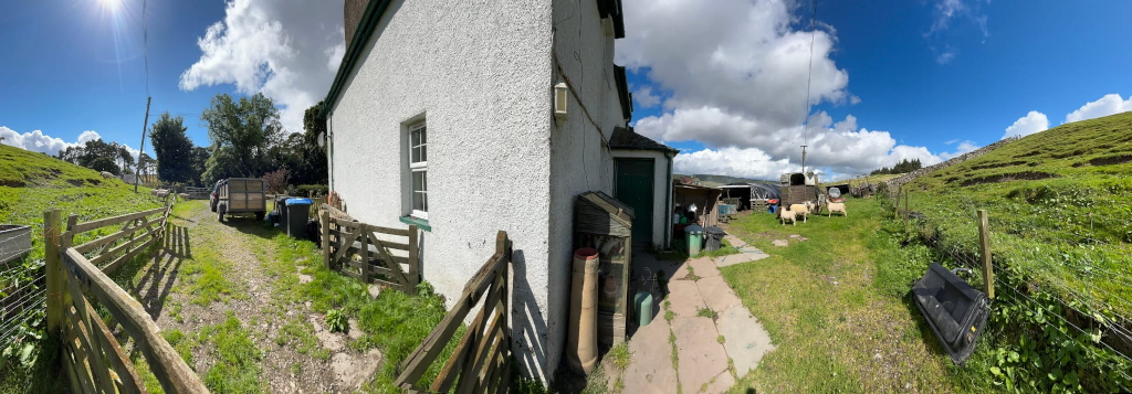 panoramic view of two sides of the farmhouse, from a long drive way to a polytunnel