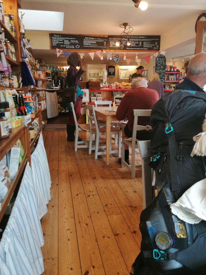 Rastafarian Communist places his hand up in the air to cafe owner